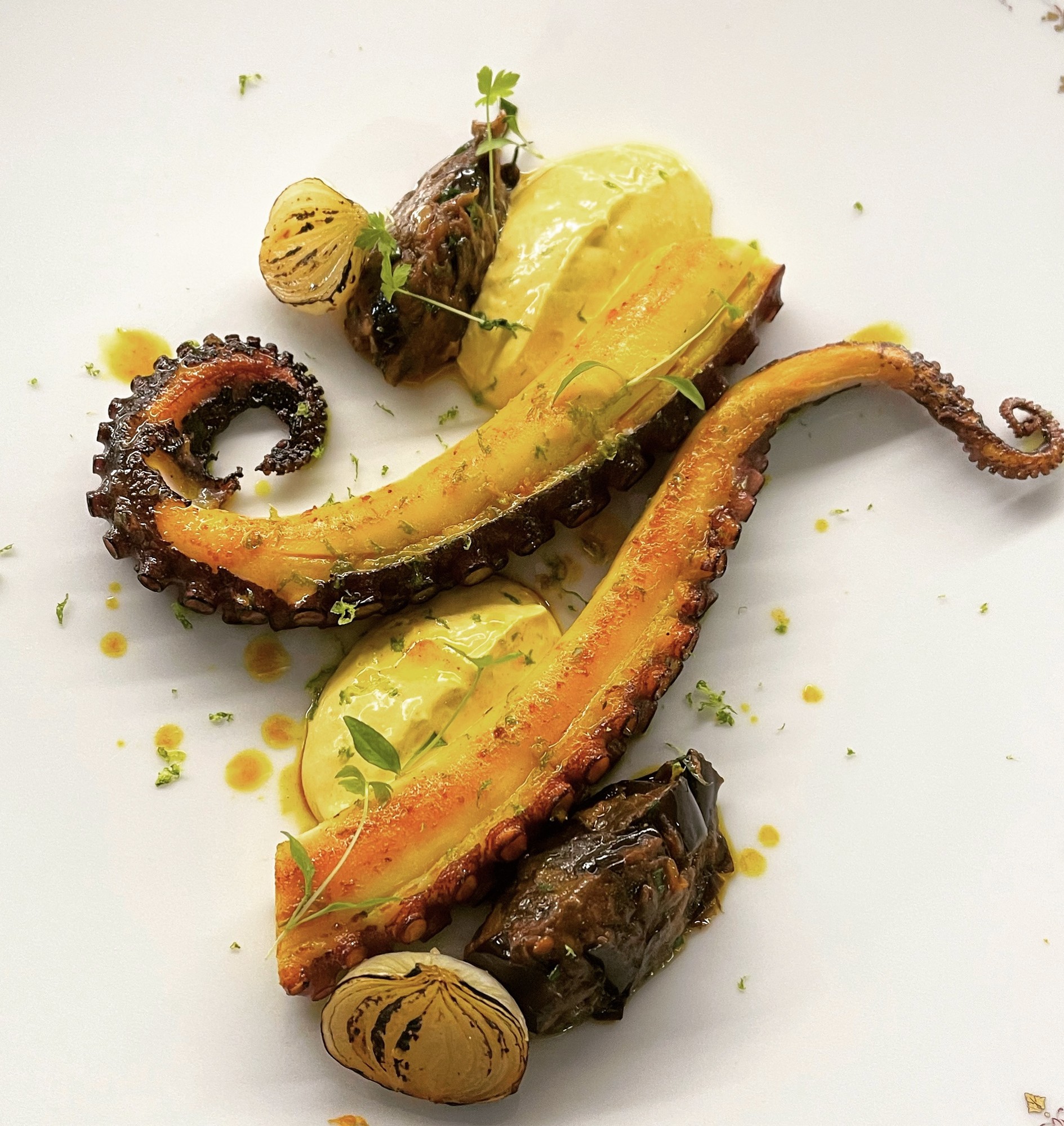 Charred octopus with saffron cream and grilled onion